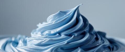 A close up of a blue frosting on a white surface photo