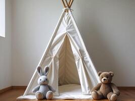 A white teepee with two stuffed animals sitting in front of it photo