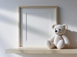 Blank Frame and Knitted Teddy Bear on Shelf.Blank Frame and Knitted Teddy Bear on Shelf. photo