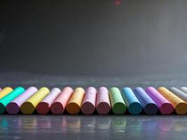 Colorful Chalk Sticks Lying Horizontally on a Dark Background photo