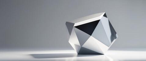 A faceted silver object rests on a flat surface. photo