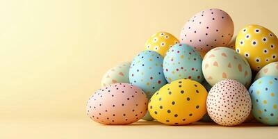 Colorful decorated eggs arranged in a creative pile against a soft yellow background photo