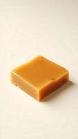 Closeup view of a square soap bar featuring a smooth golden surface photo