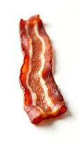 Closeup of crispy bacon strip on a clean surface captured in natural light photo