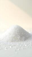 Closeup view of fine white sugar granules with light reflections and soft background photo