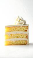 Closeup of a slice of layered cake topped with cream on a simple background photo