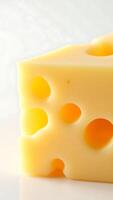 Closeup view of yellow cheese with holes showcasing texture and color variations photo