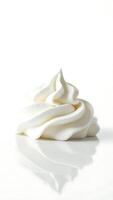 Closeup of smooth whipped cream swirl on reflective surface under soft light photo