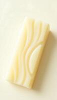 Closeup of a creamy soap bar with intricate texture on a neutral background photo