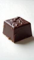Extreme closeup of a rich chocolate square with a textured surface photo