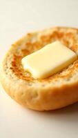 Closeup of a freshly baked biscuit with a pat of butter melting on top photo