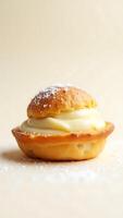 Delicious pastry topped with creamy filling and dusted with powdered sugar photo
