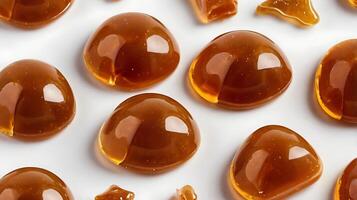 Closeup of caramel candies highlighting texture and glossy surface detail photo