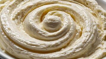 Closeup view of creamy ricotta cheese showcasing its smooth texture and swirl pattern photo