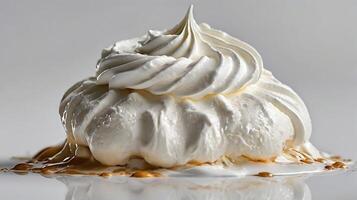 Closeup view of a dollop of whipped cream with caramel drizzle on a smooth surface photo