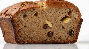 Closeup view of a sliced loaf of banana bread showcasing its texture and ingredients photo