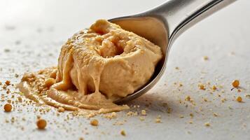 Closeup of a hummus scoop with a spoon, showcasing texture and detail photo
