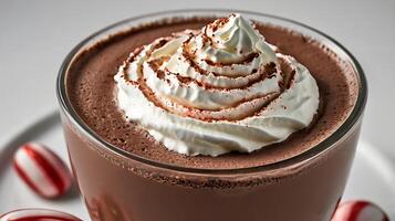 Closeup of a rich peppermint hot chocolate topped with whipped cream and cocoa photo