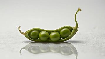 Extreme closeup of a single pea pod displaying three green peas on a smooth surface photo