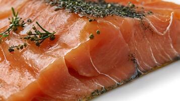 Closeup of a slice of smoked salmon garnished with herbs for culinary presentation photo
