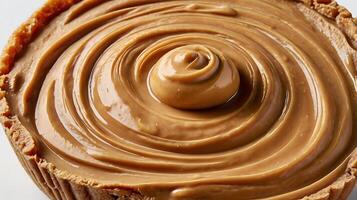 Closeup view of creamy peanut butter in a cookie crust pie shell photo
