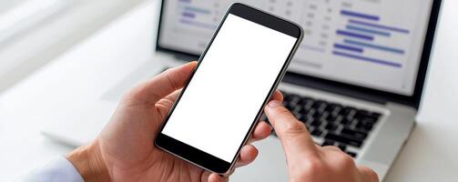 Marketing analytics performance ROI concept. Blank smartphone held in hand with a computer screen in the background. photo
