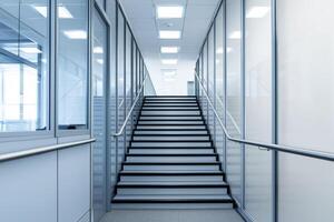 Climbing corporate ladder concept. Modern office staircase with glass walls and bright lighting. photo