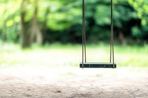 Weakness and damaged concept. Empty swing in a lush green park setting. photo