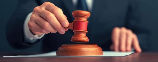 A gavel striking a sound block, symbolizing justice and authority. photo
