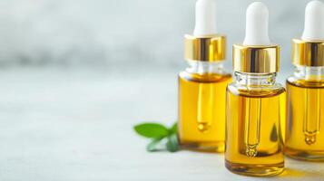 Skincare and vitamin for rejuvenation nourish concept Bottles of golden oil with droppers on a light background. photo