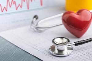 Medical tools and heart symbol on a health report background. photo