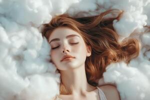 A woman sleeping in a cloud of white fluffy clouds photo