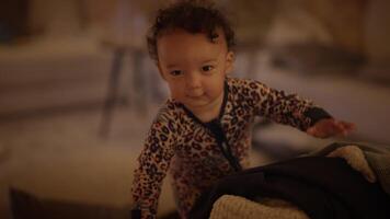 Adorable and curious toddler joyfully exploring a cozy and inviting living space at home video