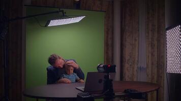 Setting Up a Studio Space for a Family Shoot Featuring a Green Screen Background video