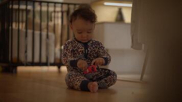 An adorable and cute baby enthusiastically playing with a colorful toy in a cozy setting video