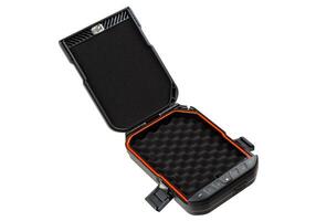 A portable black safe with its lid open, showcasing an orange lining and foam interior, ideal for storing weapons or valuables, isolated on a white background. photo