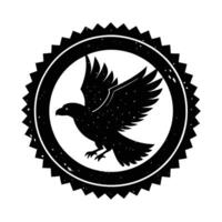 A stylized black hawk in flight is depicted within a circular, distressed badge or emblem. The design is monochromatic and suggests a vintage or retro aesthetic. vector
