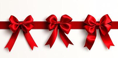 Three elegant red bows arranged symmetrically on a red ribbon against a clean white background, symbolizing celebration, gifting, and festivities. photo