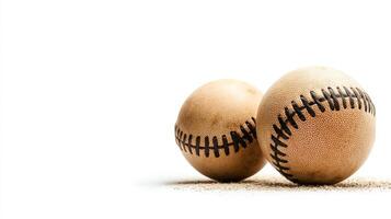 A close-up view of two baseballs resting on a sandy surface against a clean white background. This image captures the essence of America's favorite pastime, evoking nostalgia. photo