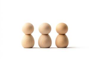 A minimalist representation of three wooden figures standing in a row, symbolizing unity, diversity, or teamwork. Ideal for concepts related to community and collaboration. photo
