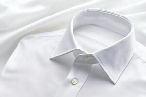 A close-up view of a crisp, white dress shirt collar laid on smooth fabric, showcasing elegance and simplicity in formal attire. photo