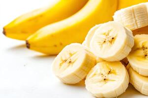Fresh bananas on a clean background, highlighting their vibrant yellow color. Sliced bananas create an appealing composition, perfect for healthy eating themes and food recipes. photo