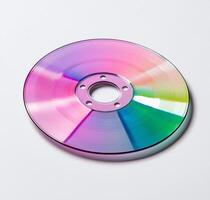 A colorful optical disc reflecting a spectrum of light, symbolizing digital data and modern technology. Perfect for illustrating concepts related to media and information storage. photo
