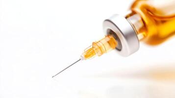 Close-up view of a syringe filled with amber liquid, showcasing the sharp needle and its precise design photo