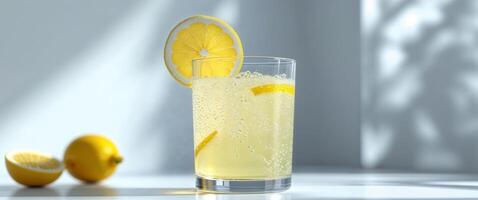 A glass of lemonade with a slice of lemon photo