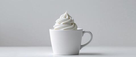 A white cup with whipped cream on top photo