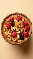 Bowl filled with fresh berries, granola, and almond flakes on a neutral background for a healthy breakfast option photo