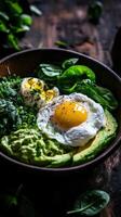 Rustic bowl filled with creamy avocado, fresh greens, and a perfectly poached egg ready for a healthy meal photo