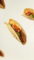 Taco filled with beef, vegetables, and spices floating against a plain background for a vibrant culinary display photo