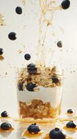 Dynamic display of yogurt, oats, and blueberries with syrup splashing during breakfast preparation photo